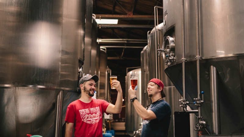 Two men tasting beer.