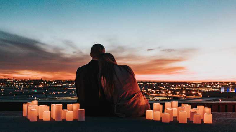 Couple cuddling on a rooftop.