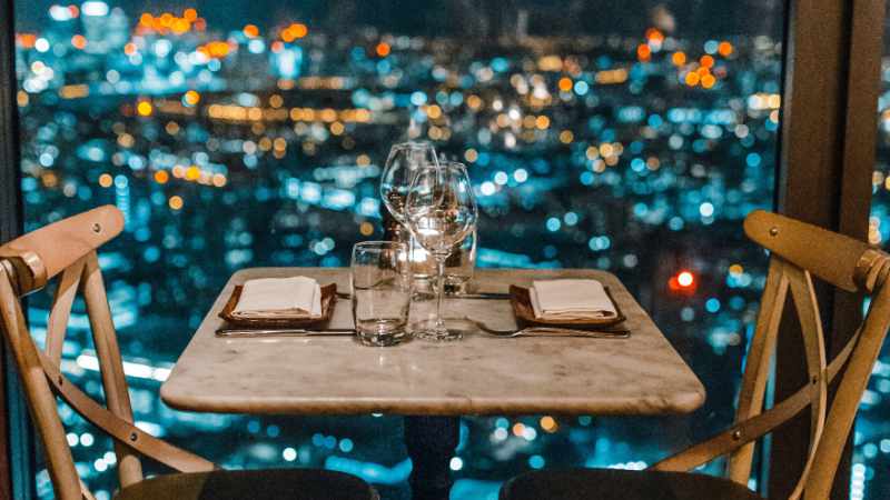 Couple cuddling on a rooftop.